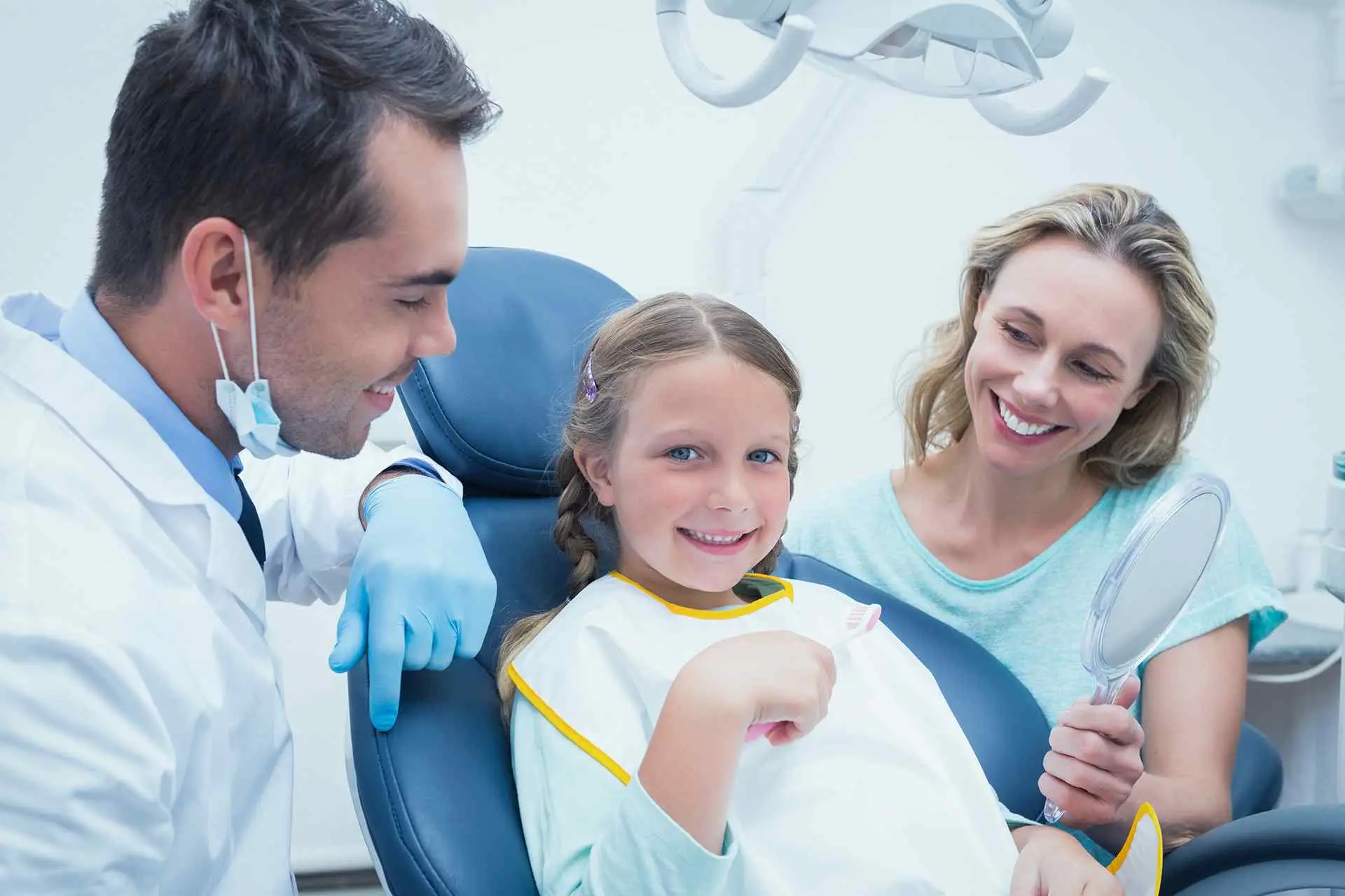 Happy girl sitting on Dental chair