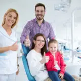 Happy family with a smiling young dentist